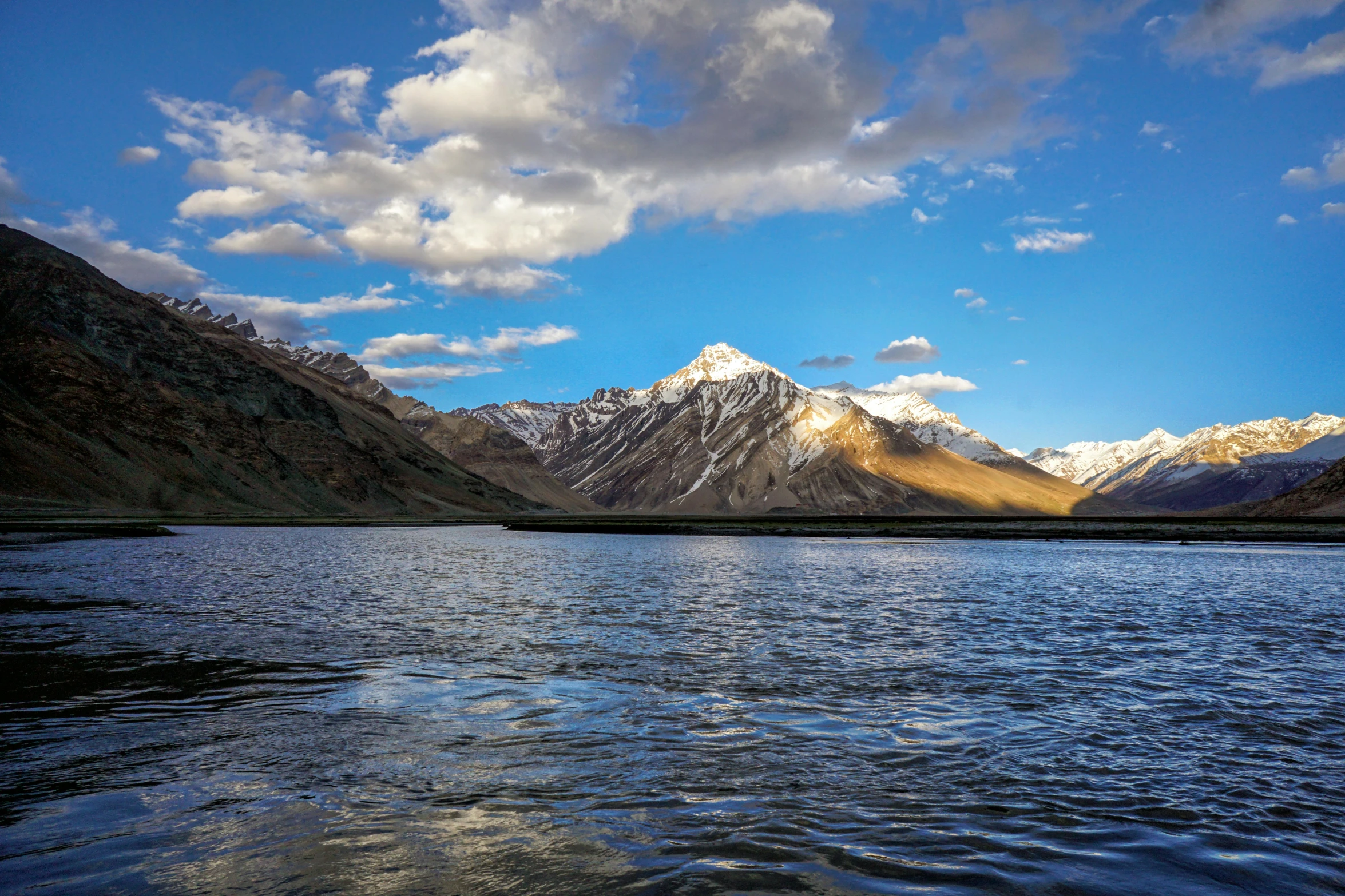 the view of a mountain lake and mountains from across the water