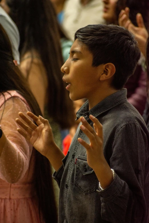 an image of people clapping in the crowd