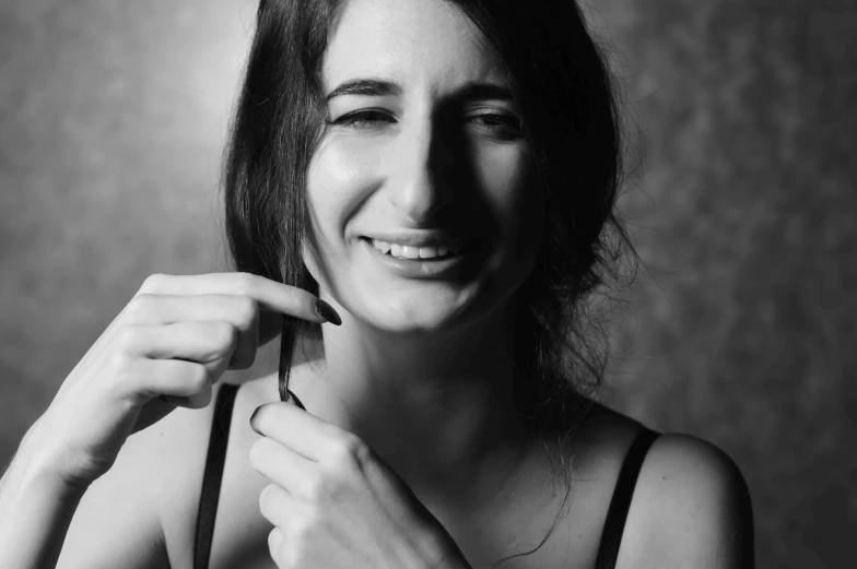 a lady poses for the camera with her fingers in her hair