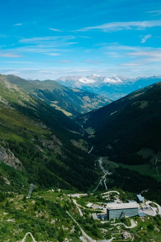 an image of a green landscape and mountain valley