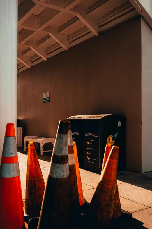 several traffic cones sit in front of a building