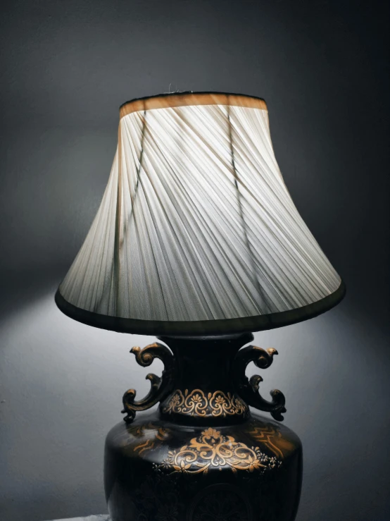 a lamp with a brown shade on the top of it