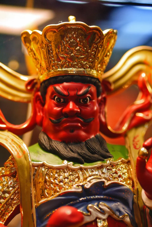 close up of statue with gold colored decorations on it