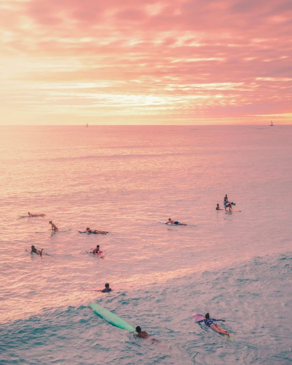 some people swimming in the water with surfboards