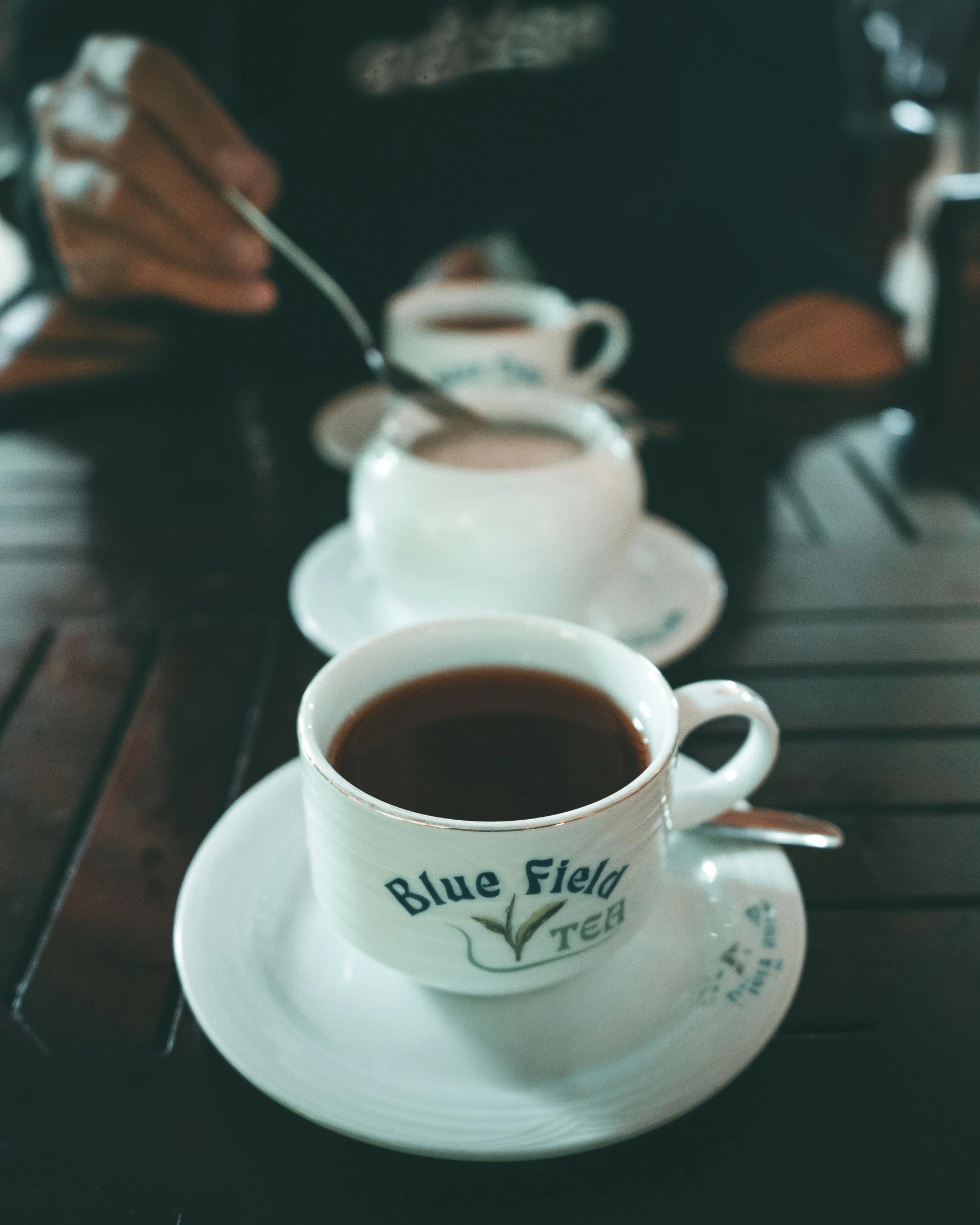 the cup of tea sits next to a plate on a table