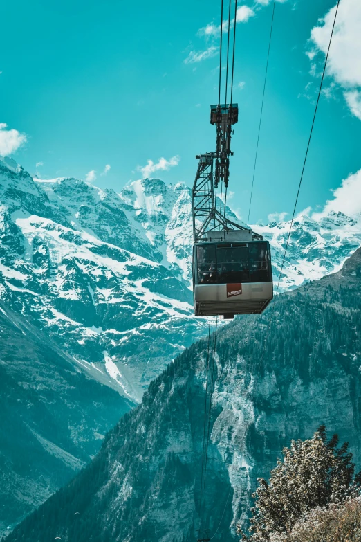 an electric cable car that is going up the mountain