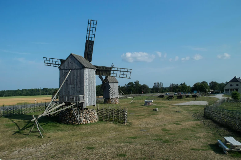 old farm buildings near an out - house on an open field