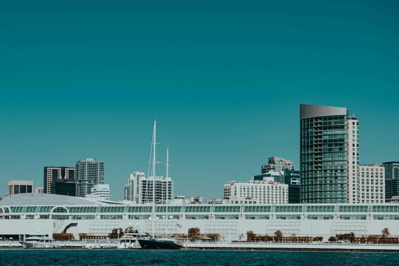 an ocean liner ship sails past a modern skyline