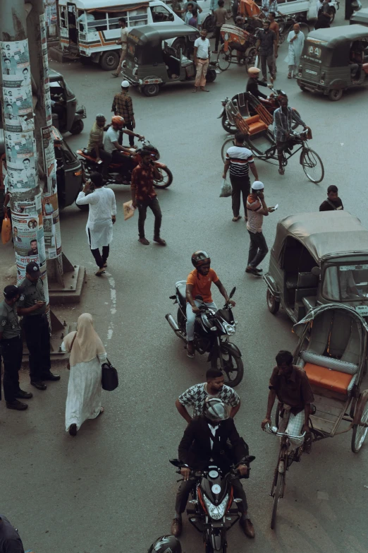 several people and bicycles on a busy street