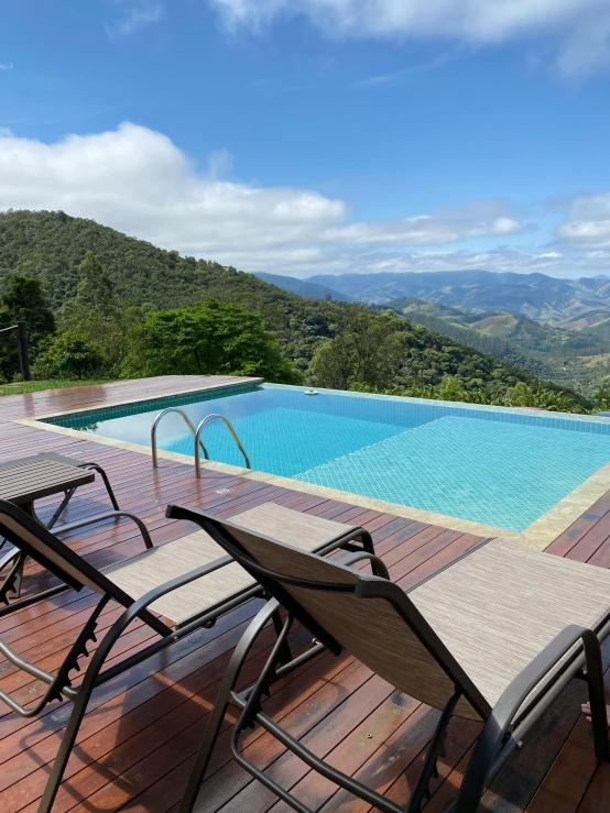 a patio and an in ground pool with a lounge chair