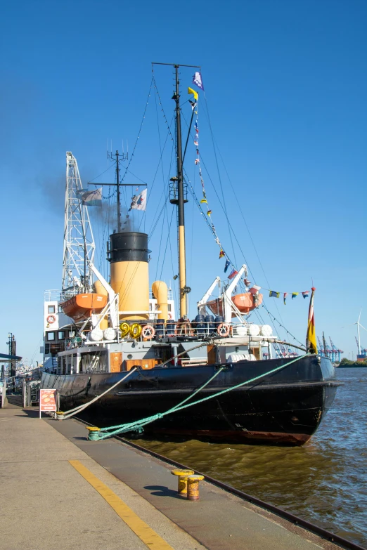 a tug boat docked at a dock by a building