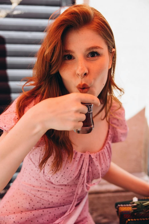 a girl sits on a chair and eats chocolate