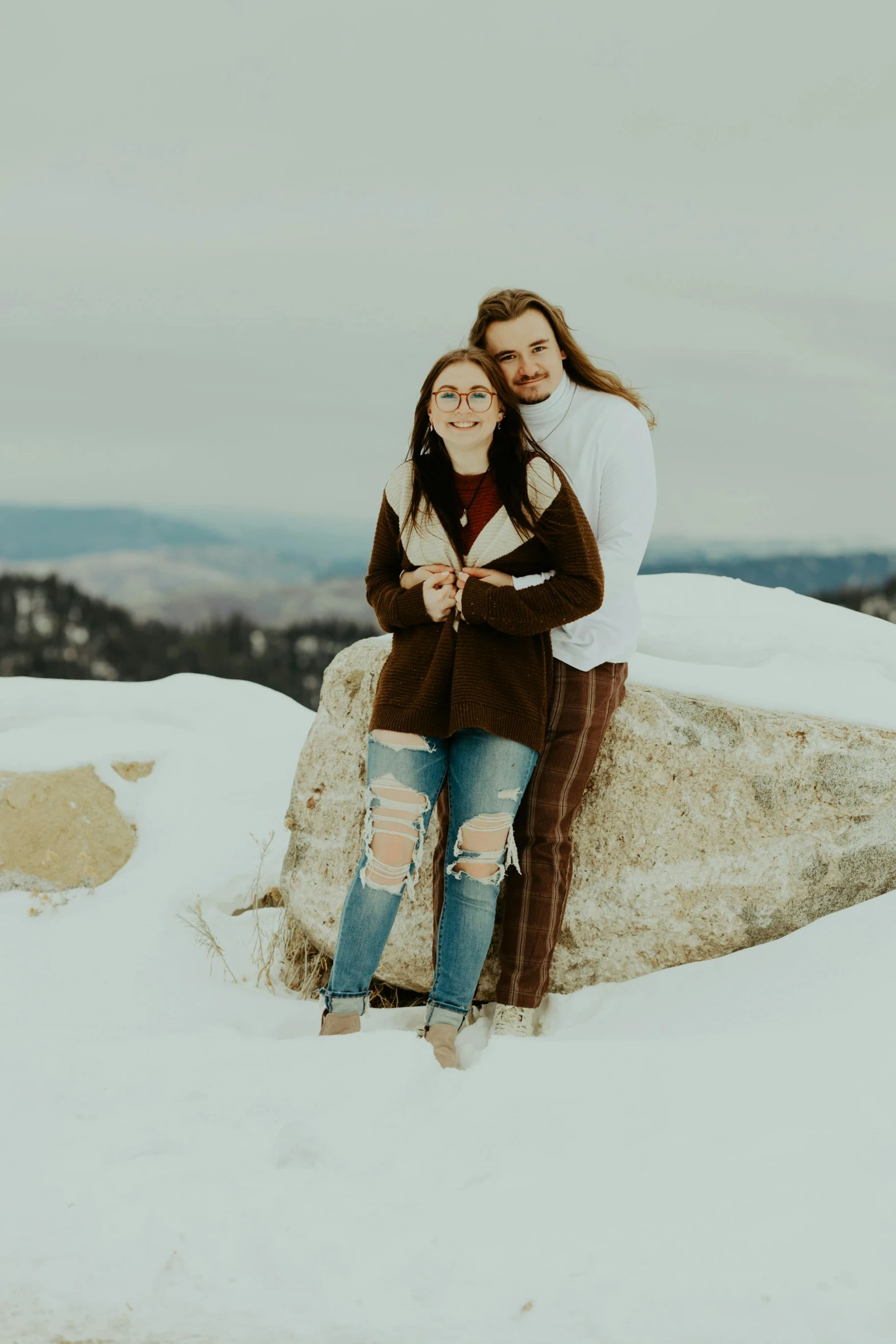 two women standing close to each other on top of a snow covered slope