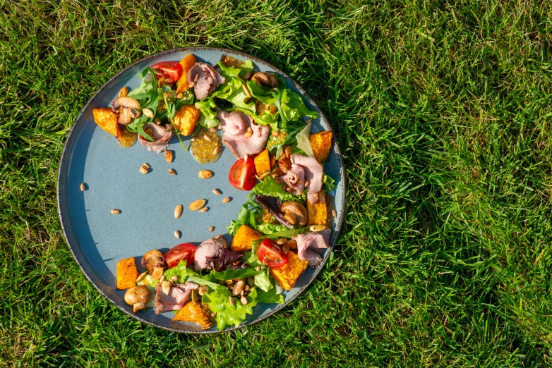 a table top platter topped with salad and nuts