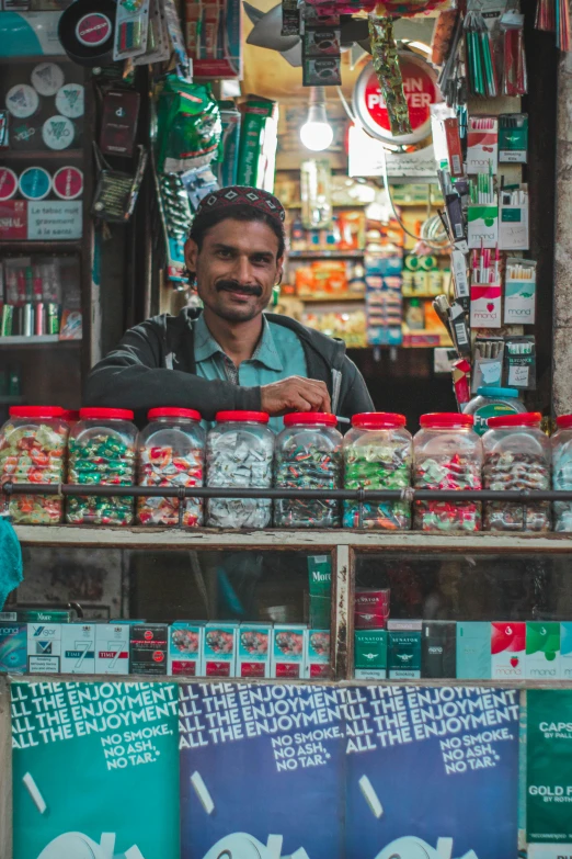 a man is standing behind the glass in his shop