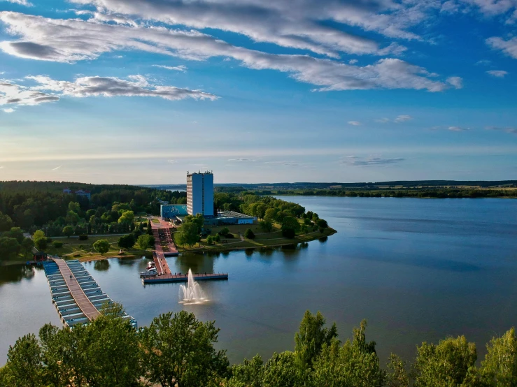 an aerial view of a lake and a tower on the shore