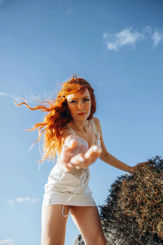 woman posing for the camera outdoors with her hair flying
