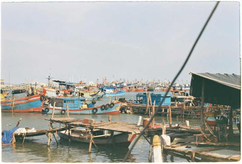 many boats at a dock with one boat pulled up