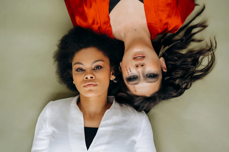 two women with dark makeup and their bodies painted as cattails