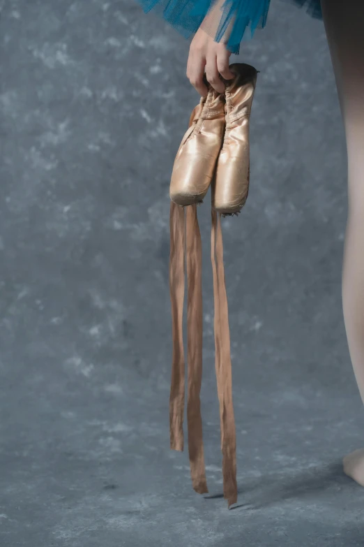 the back of a person's feet with a pair of ballet shoes