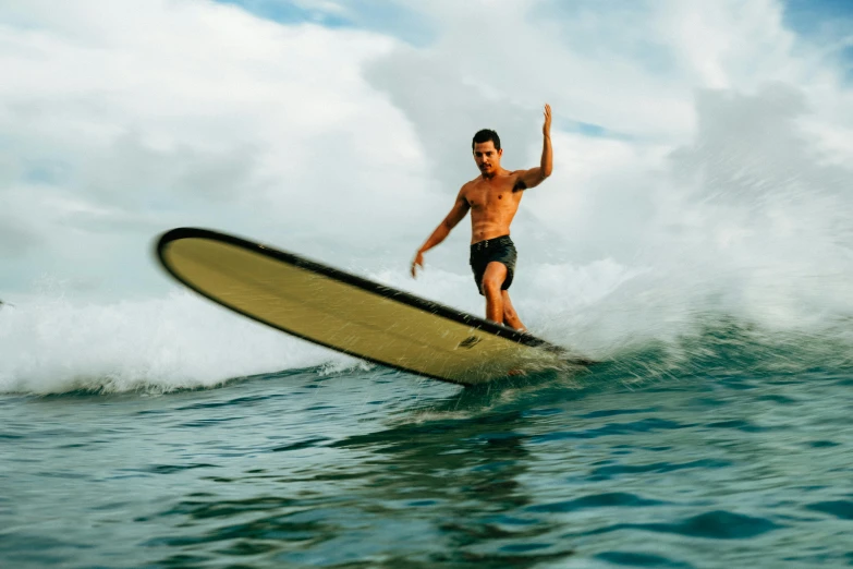 man riding on top of a surfboard in the ocean