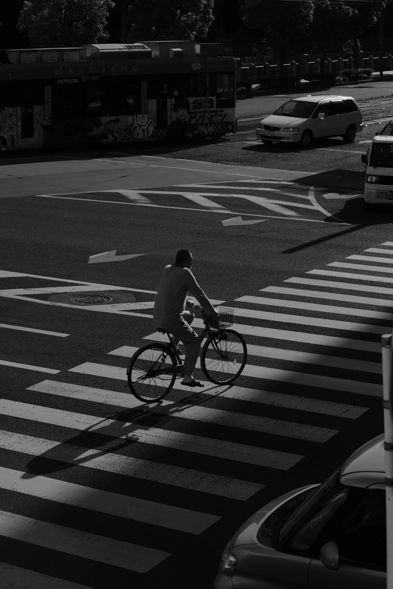 a person riding a bike across a street