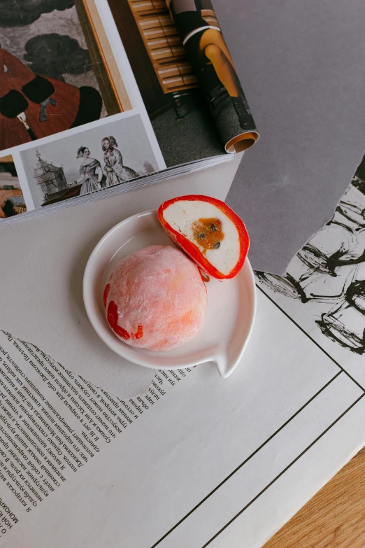 a pink ice cream covered in fruit next to a pen