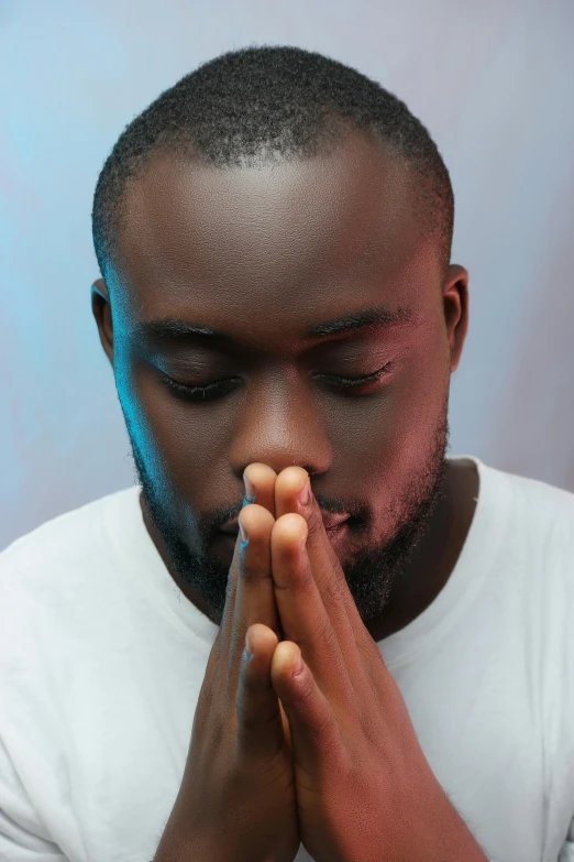 a man with his eyes closed praying