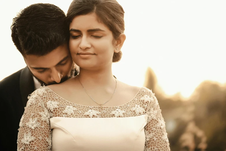 a bride and groom with their eyes closed in love