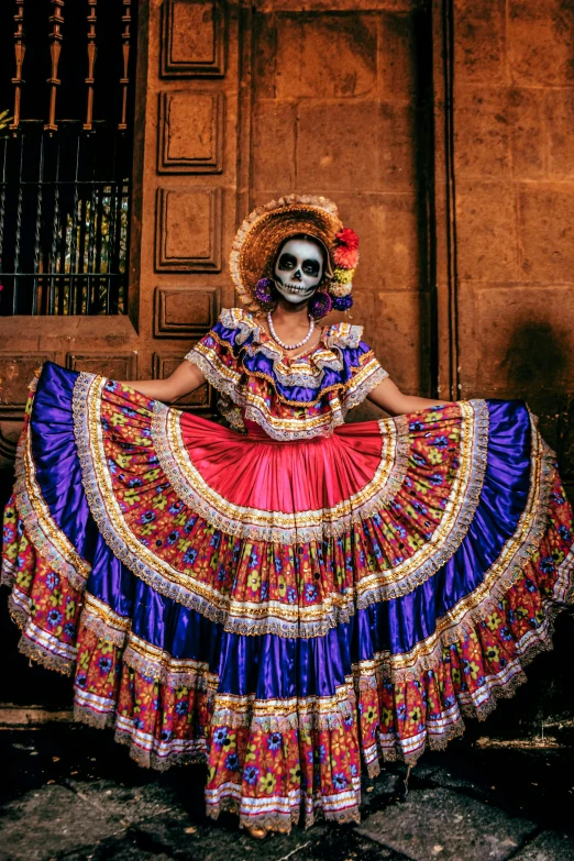 a woman in a skeleton face paint costume poses