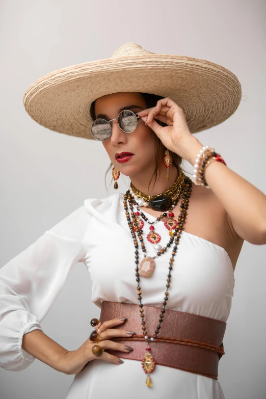 a woman with an oriental hat and other accessories is posing for a picture