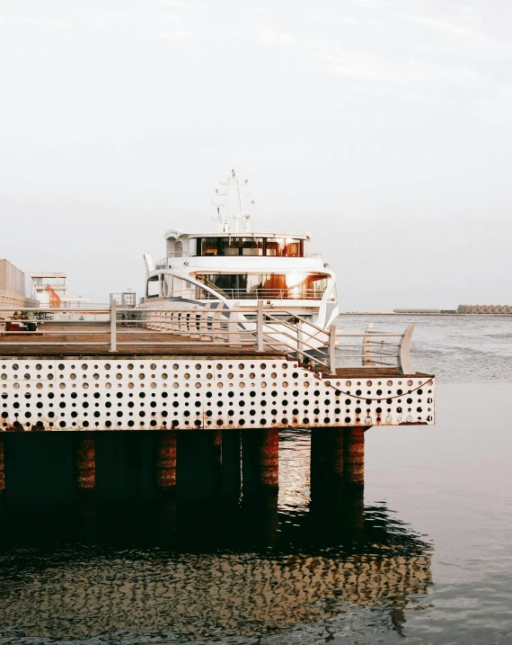 a small ferry sits anchored at a pier