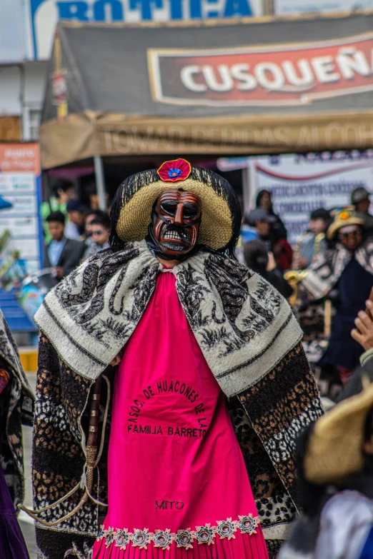 a person dressed in costume and face paint during a carnival