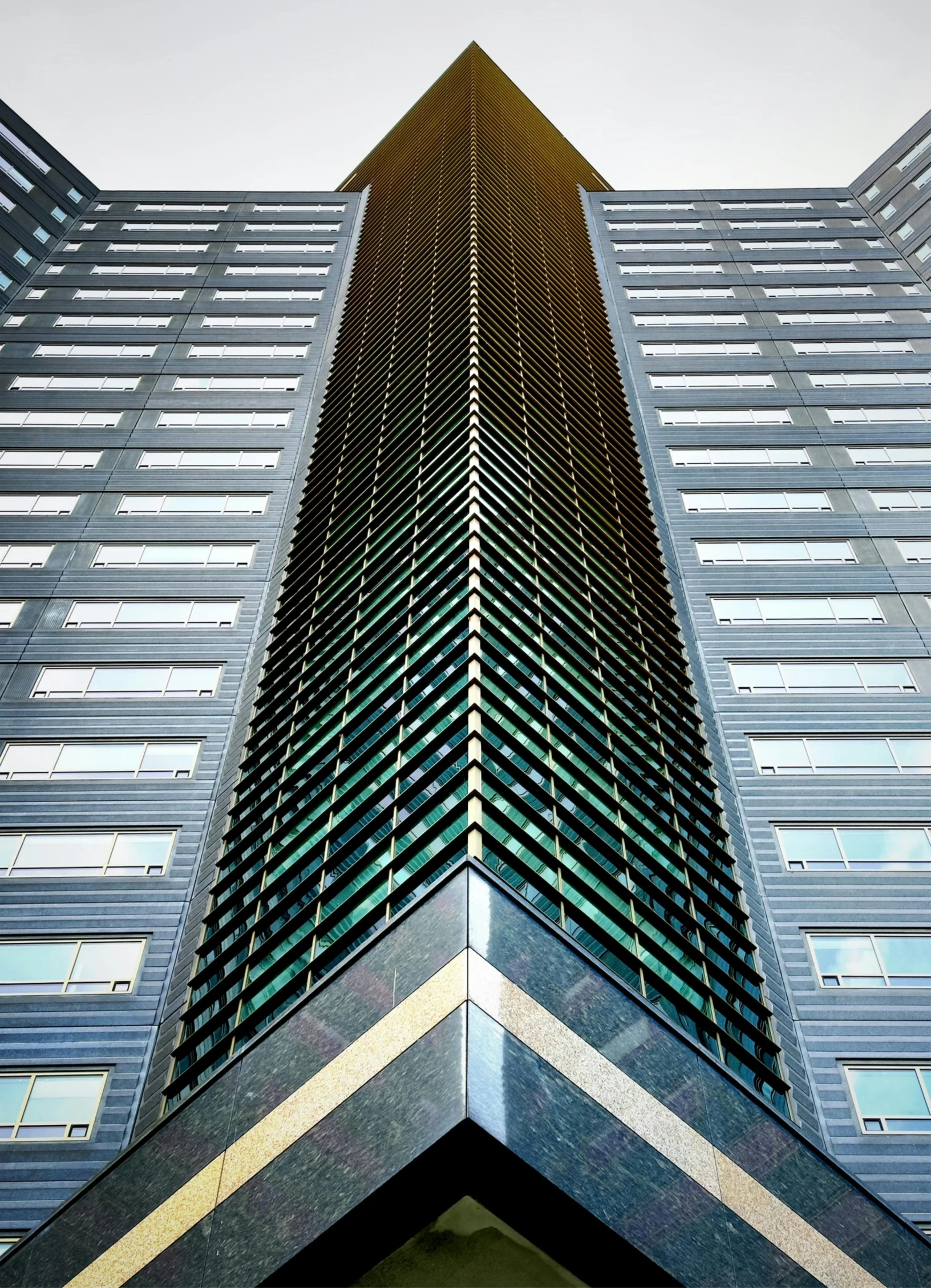 the front side of a tall building with some windows