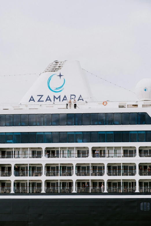 a cruise ship under a cloudy sky on a river