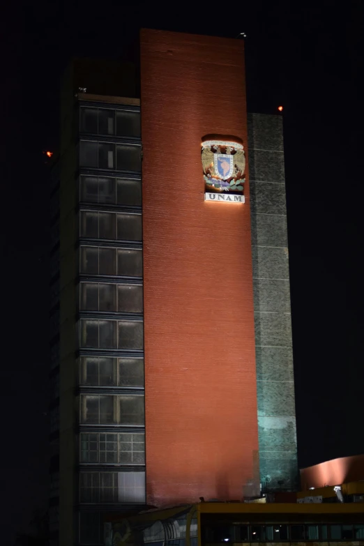 an office building with a very tall clock tower at night
