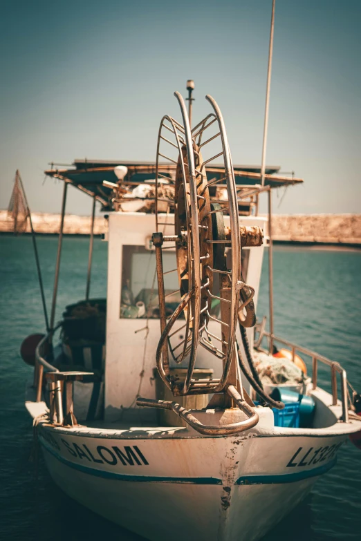 a boat sitting in the water with some old parts on it