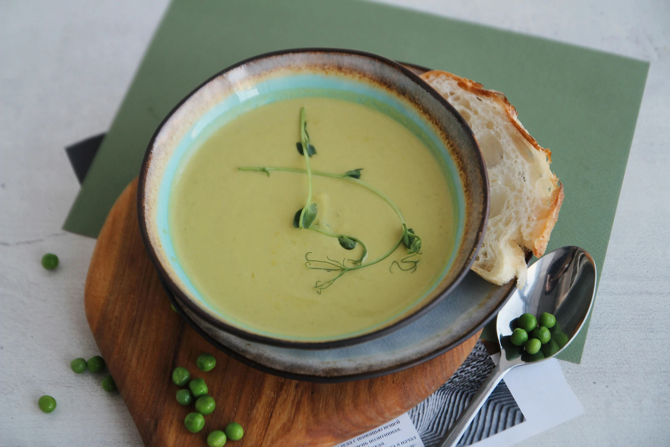 there is a bowl of soup next to a spoon