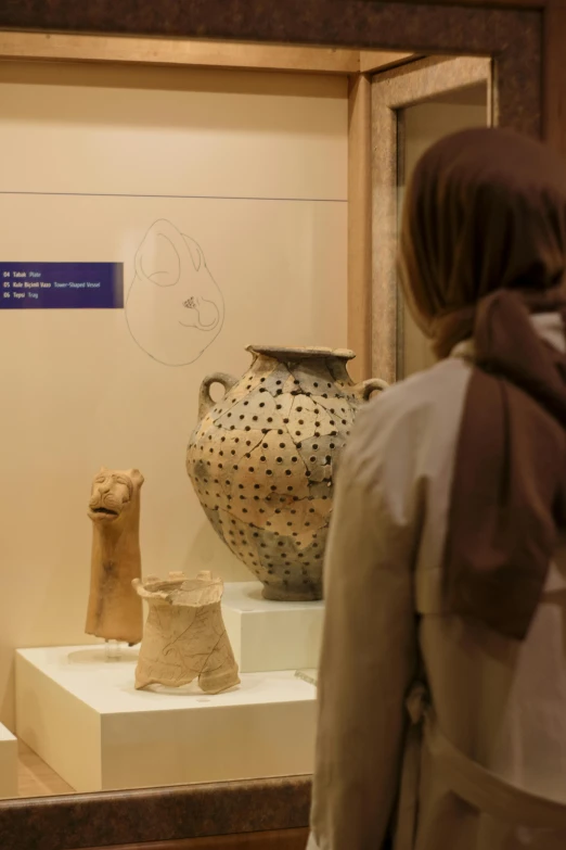 two people looking at an art display in a museum