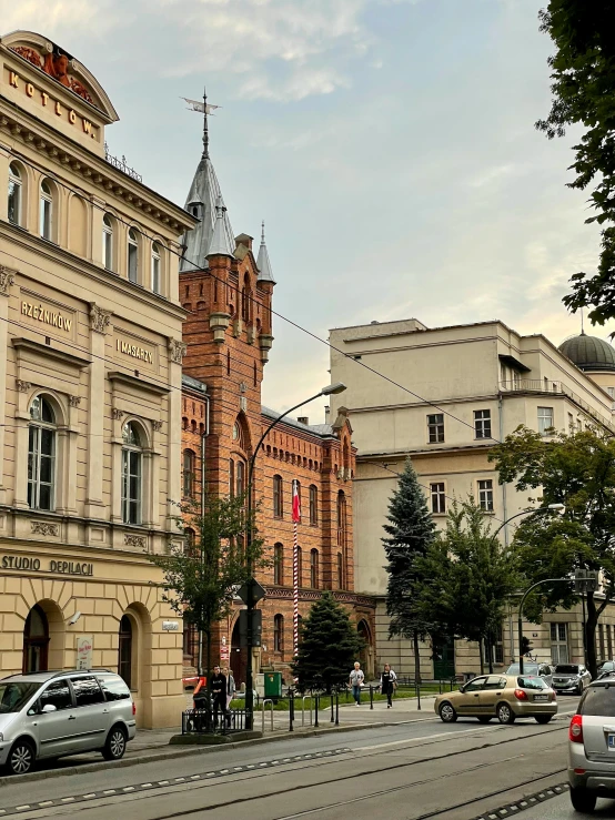 a group of buildings with trees lining a street