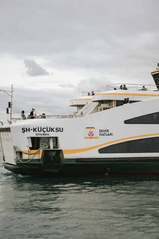 the big white ferry is pulled into the dock