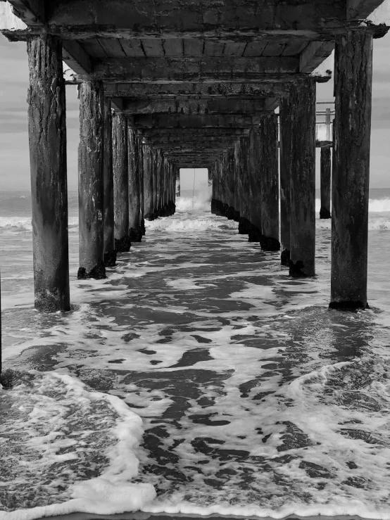 some very pretty water under a very big long pier