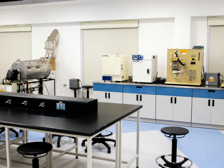 the machine room in a science institution with a work bench and chairs