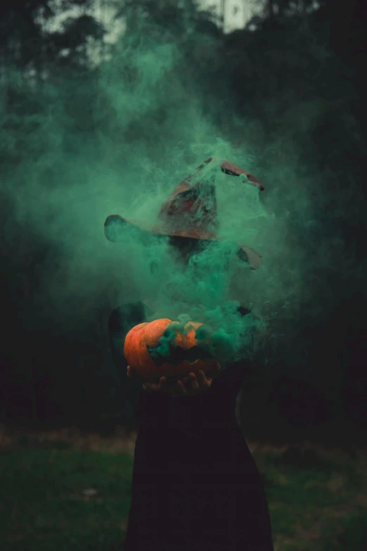 a person with their head covered in green smoke