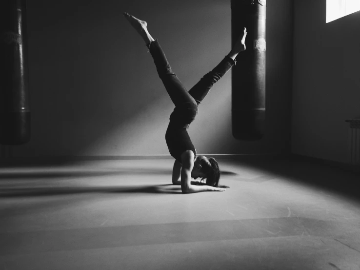 a person doing a hand stand on their feet