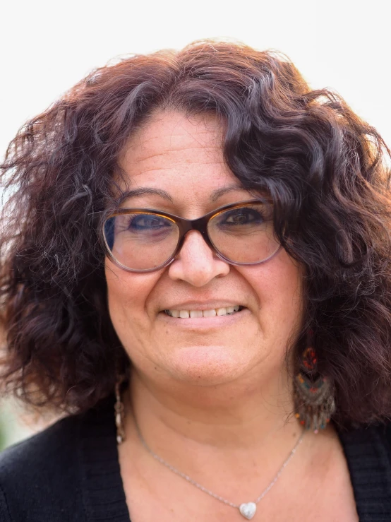 a close up of a person with glasses smiling