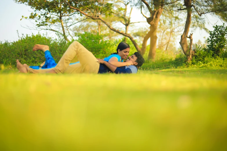 two young women lying in the grass together