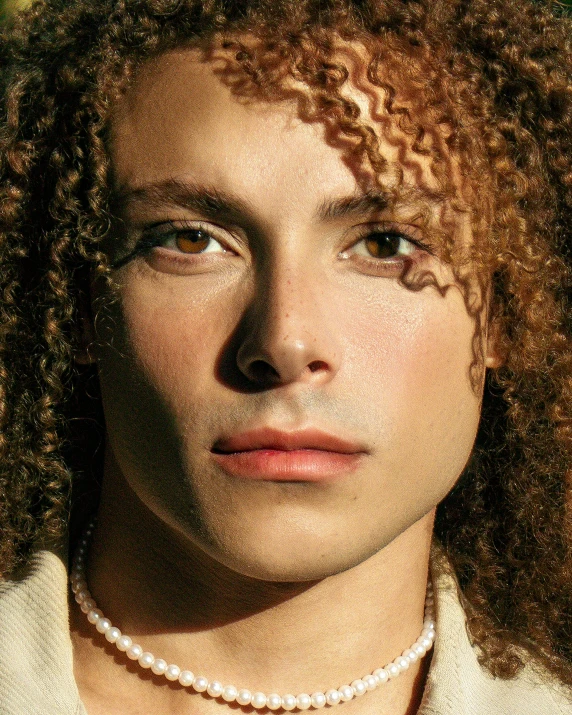 a young woman with an afro looks into the camera