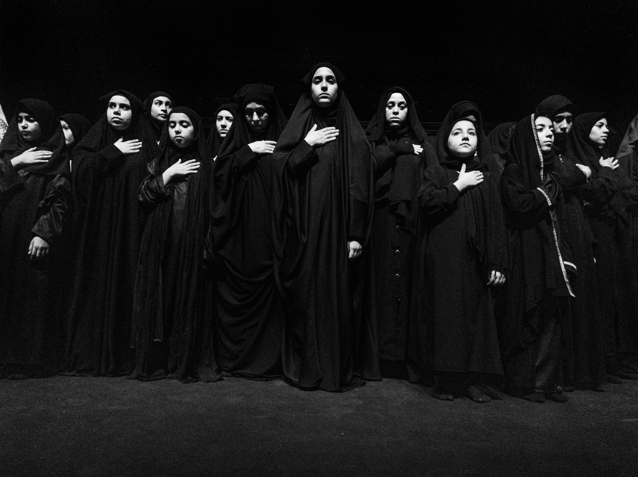 a black and white po of a row of female demonic witches