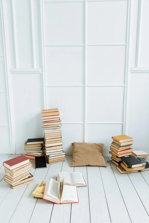 a pile of books sitting on top of a wooden floor